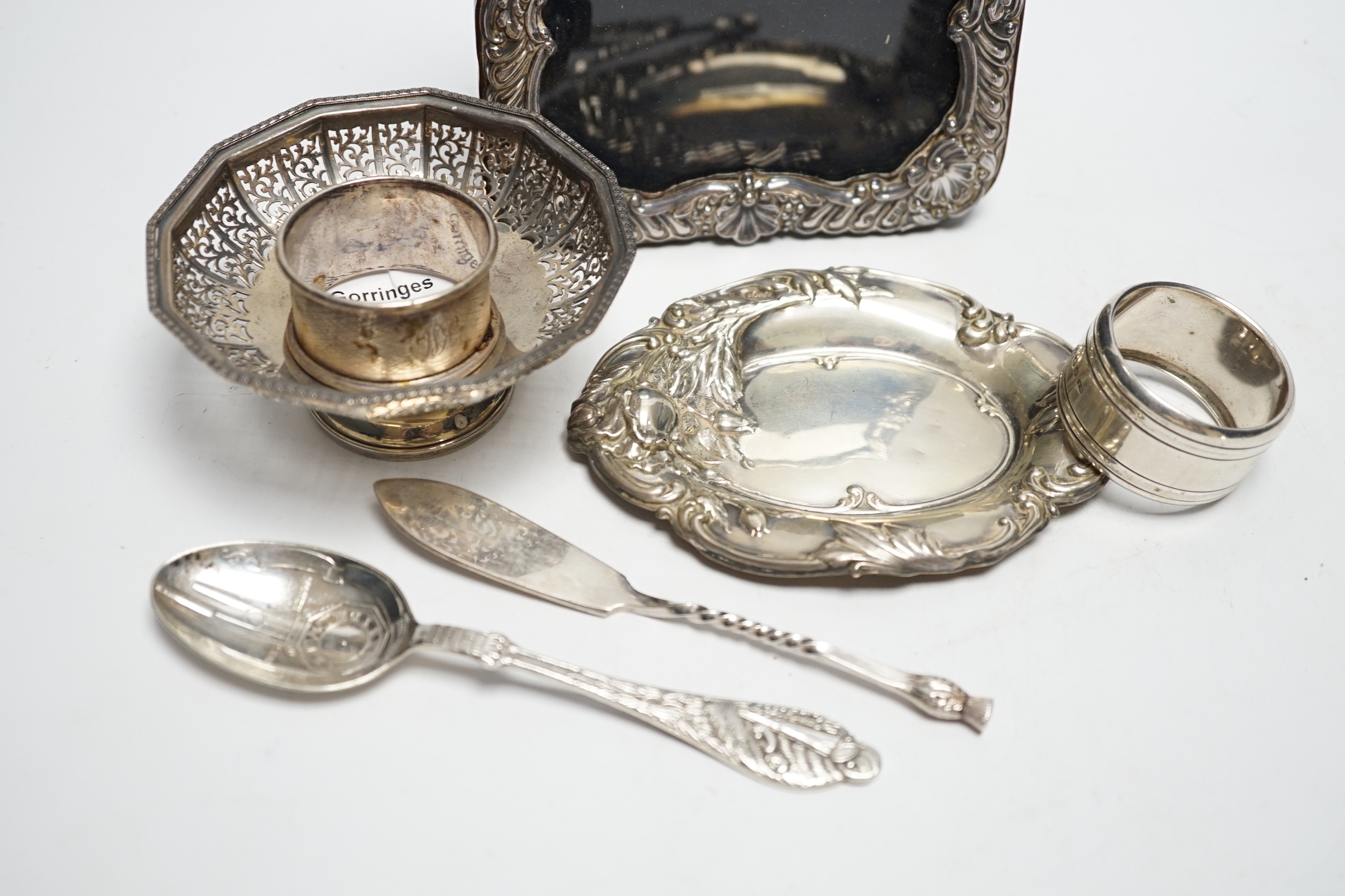 Sundry small silver and plate including a mounted photograph frame, napkin ring bonbon dish, plated butter knife, etc.